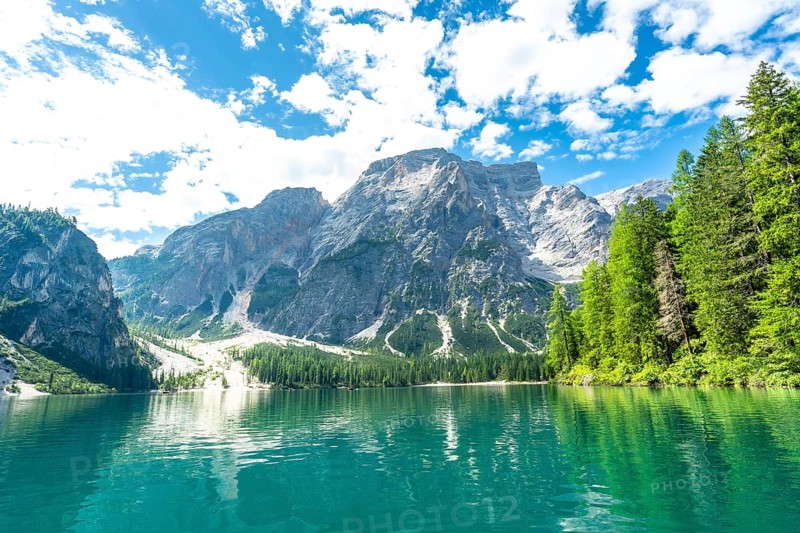 Emerald waters reflecting the majestic dolomites peaks at lake braies, a stunning natural wonder in the heart of the italian alps