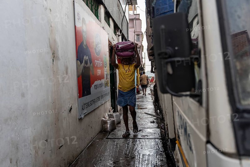 GUWAHATI, INDIA - MAY 1: Labourers carries goods in a wholesale market, in Guwahati, India, on May 1, 2025. May Day or Workers Day is a global holiday celebrated on May 1st to honor workers and their contributions, Asia