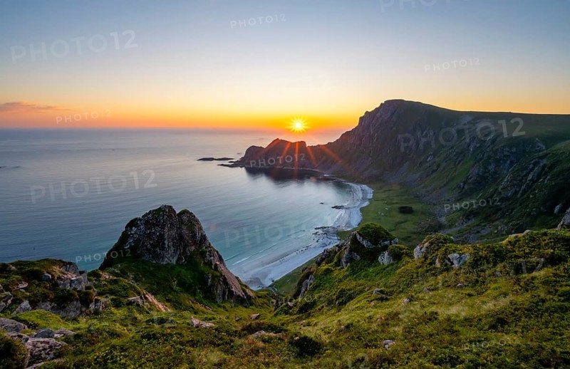 View of coastal landscape at sunset, cliffs and summit of Måtind or Måtinden, Høyvika beach and sea, Andøya island, Vesterålen, Nordland Norway