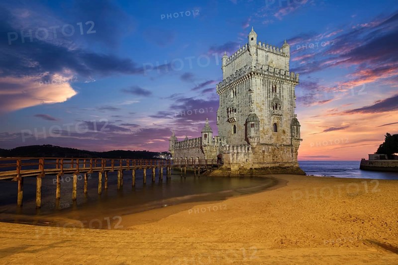 Belem Tower or Tower of St Vincent, famous tourist landmark of Lisboa and tourism attraction, on the bank of the Tagus River (Tejo) after sunset in dusk twilight with dramatic sky. Lisbon, Portugal, Europe