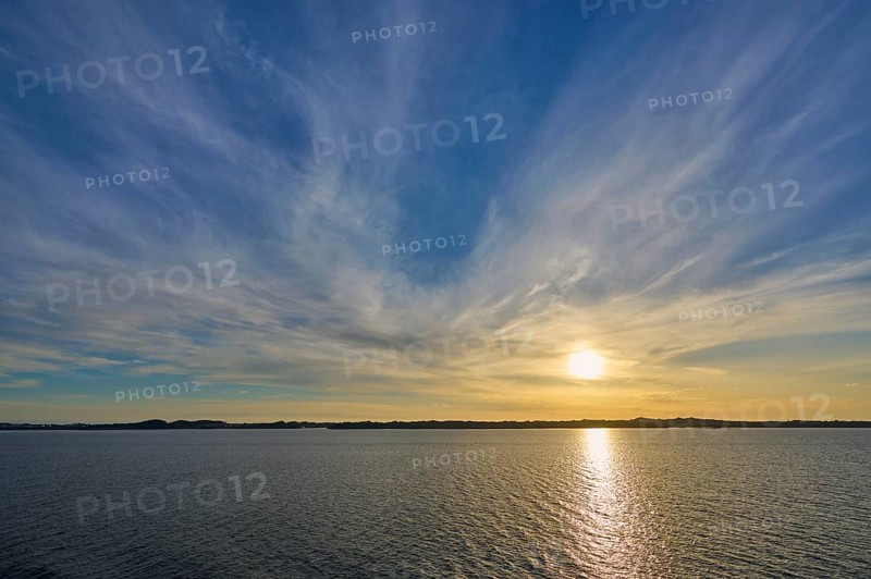 Sunrise over the calm sea, with wide sky and soft clouds in warm light, Bergen, Vestland, Norway, Europe