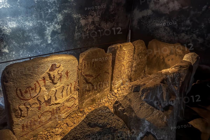 Carved figures in stone slabs inside the King's Tomb, a Bronze Age tomb in Kivik, Simrishamn Municipality, Skåne County, Sweden, Scandinavia, Europe