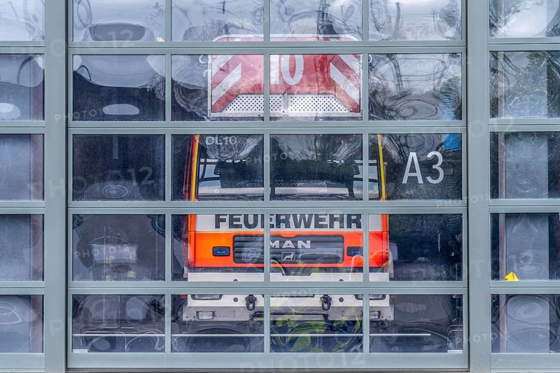 Fire brigade, fire station, modern fire station, glass Tor tor, emergency vehicles in the vehicle hall, Cologne, North Rhine-Westphalia, Germany, Europe