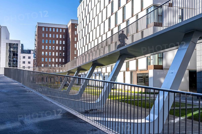 The Parkbruk, cycle and pedestrian bridge in the city centre of Antwerp, crosses a multi-lane city centre road with tram lines and thus connects two lively city districts Kop Spoor Noord and Eilandje, 140 metres of curved ramp on the western side for driving up and down, walking, Belgium, Europe