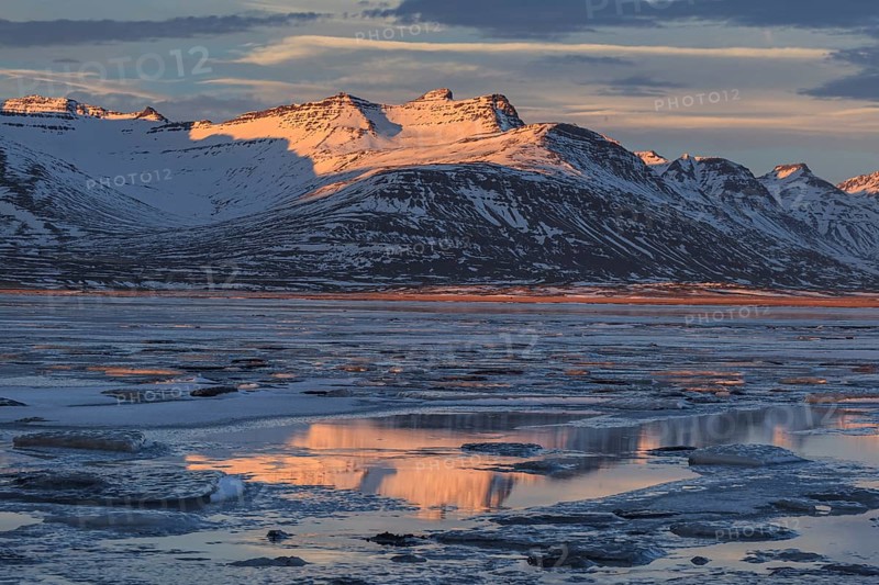 Morning light on Bergen on the coast, icy fjord, Breiddalsvik, East Fjords, Iceland, Europe