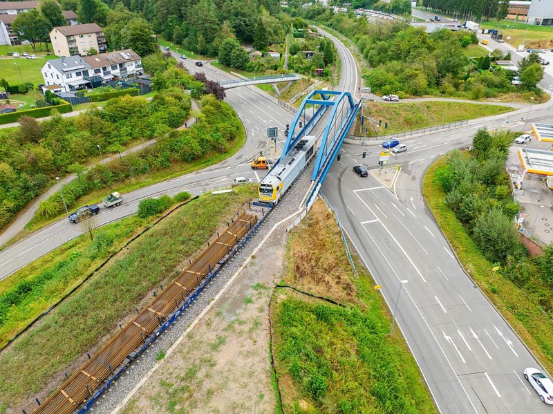 Railway line and train on a bridge over a road crossing, track construction, rail delivery for Hermann Hessebahn, Calw, Black Forest, Germany, Europe