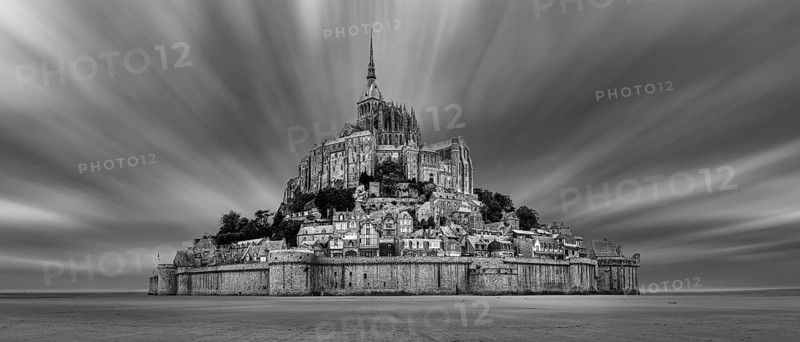Impressive view of Mont Saint-Michel in black and white, surrounded by dramatic clouds, Le Mont-Saint-Michel