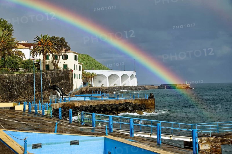Promenade in rainy weather with rainbow on the beach of the Atlantic Ocean, municipality of Santa Cruz, Madeira, Portugal, Europe