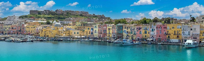 Procida Island, Campania, Italy, June 10, 2022: Italy, Procida Island shoreline with shops and colorful old city buildings facing the sea, Europe