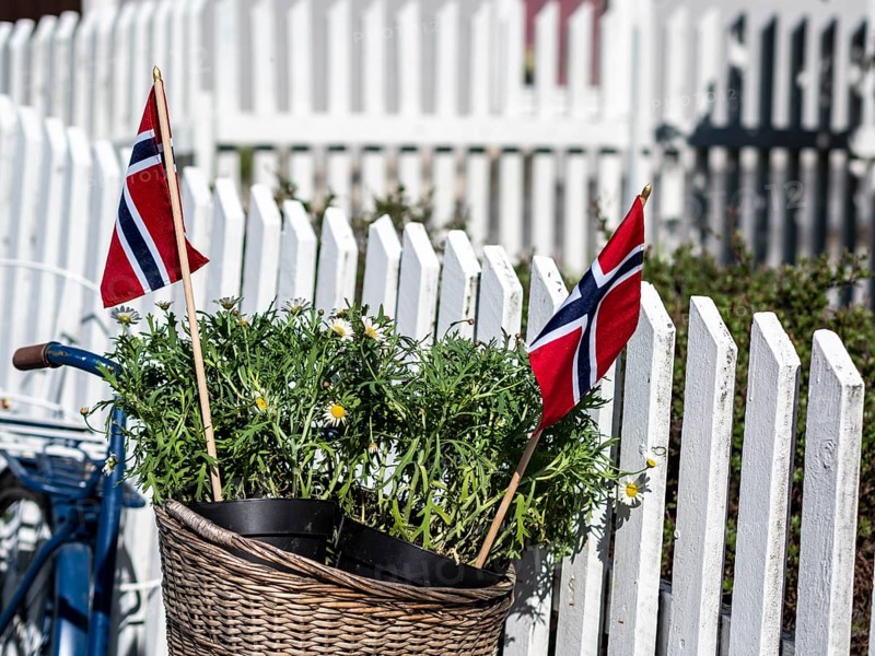 Decorated bicycle at a white fence, norwegian national day, village Solvorn at the Sognefjord, Norway, Europe