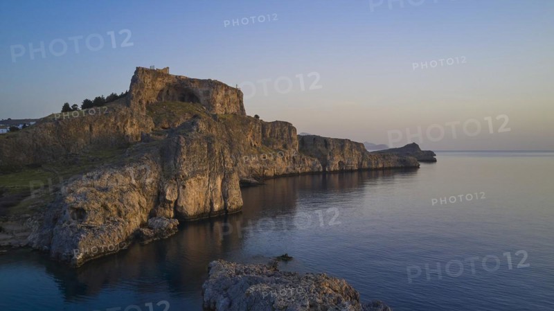 Drone shot, first morning light, Lindos, Acropolis of Lindos, Picturesque castle on a cliff overlooking the sea caught in the stillness of dusk, Archaeological site, Lindos, Rhodes, Dodecanese, Greek Islands, Greece, Europe