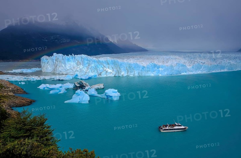 El Calafate, Patagonia, Argentina, Perito Moreno Glacier in Los Glaciares National Park. The Perito Moreno Glacier is part of the Patagonian ice field, the Campo Hielo Sur, the third largest freshwater reserve in the world. It is located in the province of Santa Cruz on Lago Argentino, the country's largest lake. The Perito Moreno Glacier is up to 30 kilometres long and 5 kilometres wide. Its edge is 70 metres high at its highest point. Small icebergs that have broken off from the glacier float in Lago Argentino. The glacier is one of the most beautiful sights in South America and is one of the most visited attractions in Argentina. Tourists can take an excursion boat to the glacier, South America