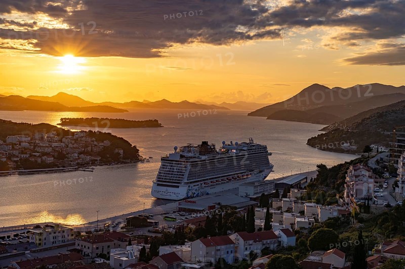 Cruise ship Norwegian Escape in the harbour of Dubrovnik at sunset, Croatia, Europe
