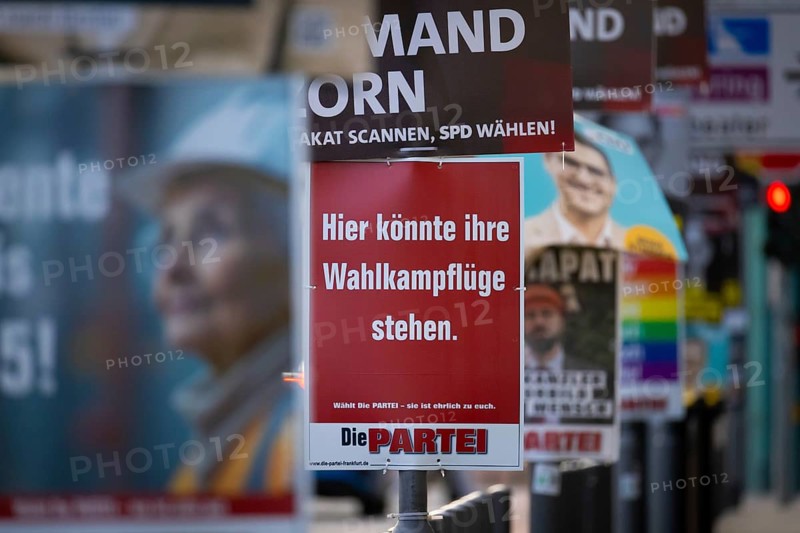 A poster with the inscription Here could be your election campaign wings. hangs between numerous election advertising posters for the Bundestag election on 23 February 2025, Mainufer, Frankfurt am Main, Hesse, Germany, Europe