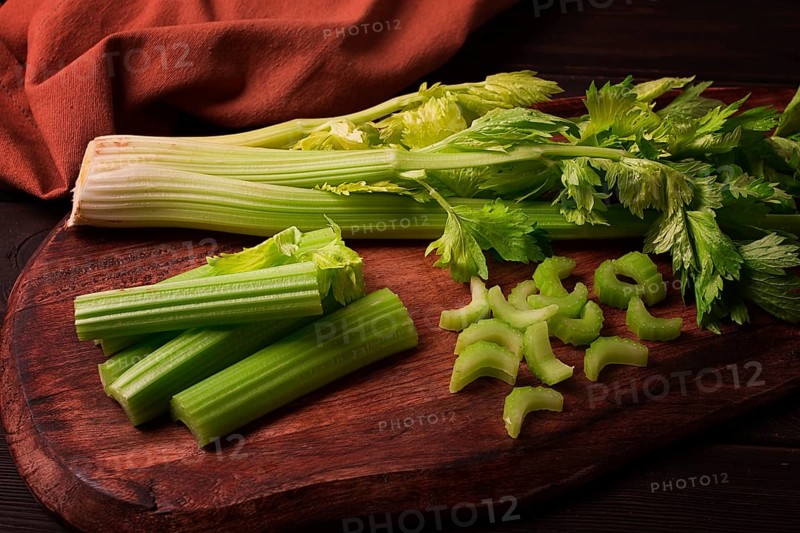 Fresh bunch of celery, top view, no people, on a dark background
