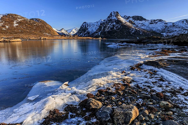 Sunrise, morning light, steep mountains and fjord, ice, winter, Flakstadoya, Lofoten, Norway, Europe