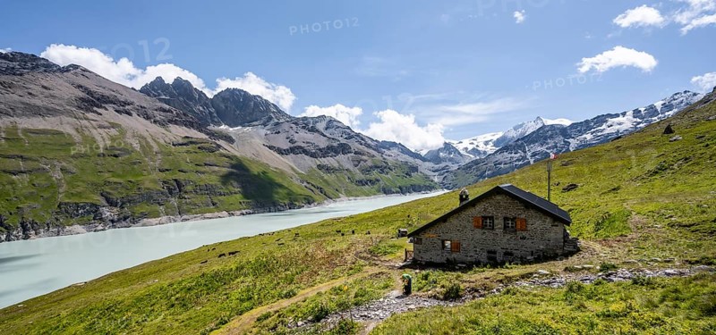 Alpine hut on a blue mountain lake, Lac des Dix reservoir, behind mountain peak Mont Blanc de Cheilon, Hérménence, Valais Alps, Valais, Switzerland, Europe
