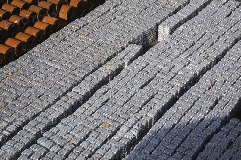 Top view of aluminium ingots and coils of flat rolled steel waiting for shipment at a terminal in the port of Salerno, Italy, Europe