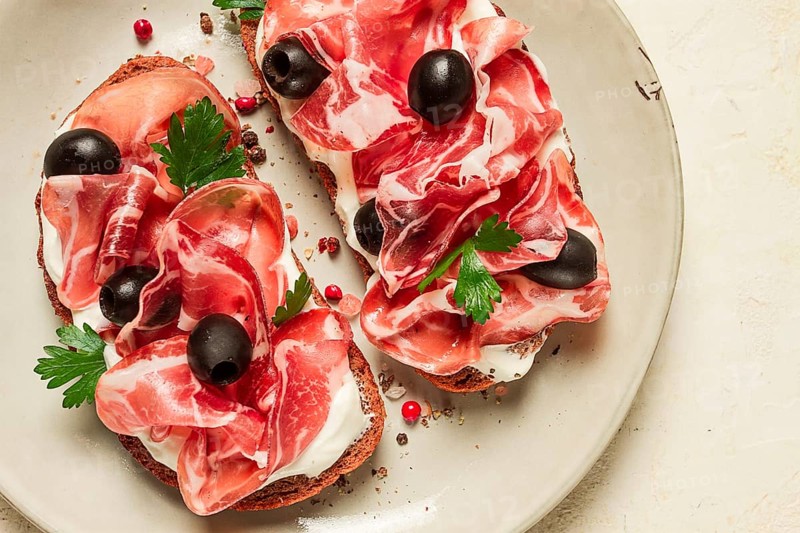 Sandwich with cream cheese, prosciutto with olives, breakfast