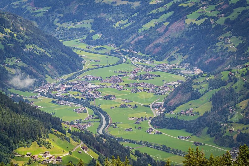Green valley with village and river in the Alps, surrounded by mountains, Mayrhofen, Zillertal. Austria