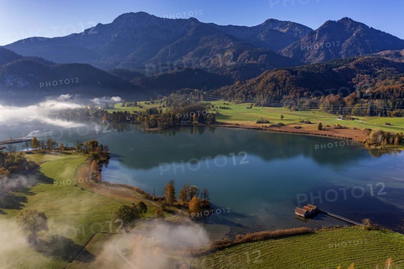 Aerial view of a lake in front of mountains in autumn, midday light, view of Herzogstand and Heimgarten, Lake Kochel, foothills of the Alps, Bavaria, Germany, Europe