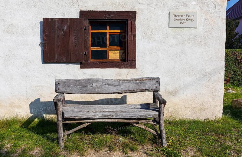 Wooden bench in front of the Stenz poorhouse from 1826, today a pilgrims' hostel on the Via Regia, Königsbrück, Saxony, Germany, Europe