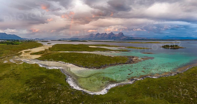 View of mountain range Seven Sisters from Herøy island, light mood with rainbow, Helgeland coast, Nordland, Norway, Europe