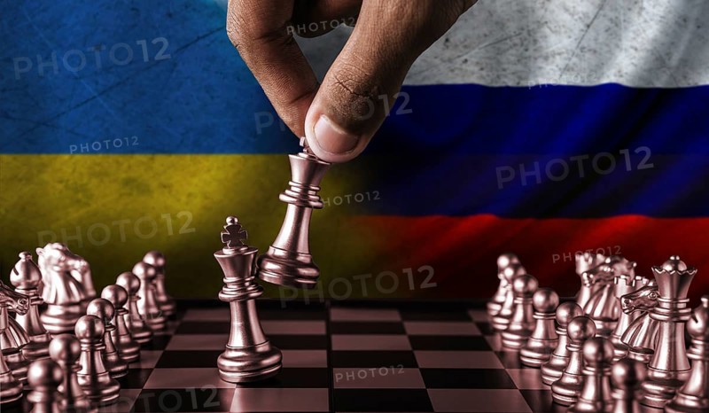 Russia vs Ukraine flag concept on chessboard. Political tension between Russia and Ukraine. Conflict between Russia and Ukraine over chess pieces