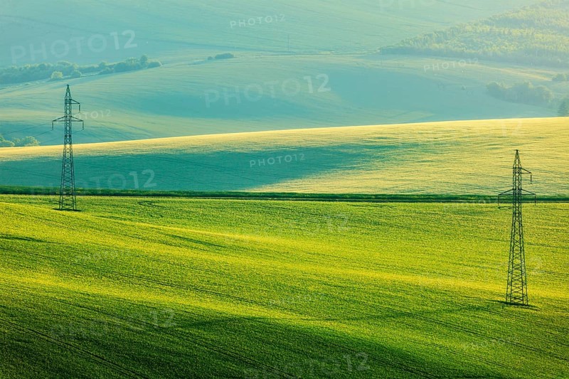 Moravian summer rolling landcsape with two power line tower. Moravia, Czech Republic, Europe