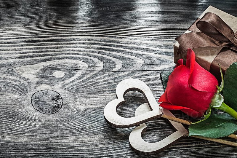 Wooden hearts red rose present box on wood board celebrations concept