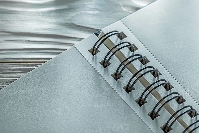 Spiral notebook on white wooden board