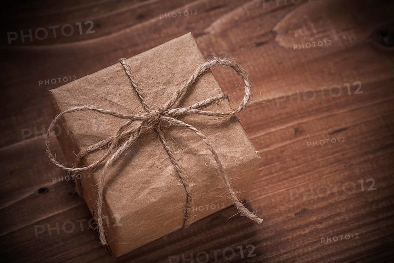 Classical vintage gift box with string bow on wooden board