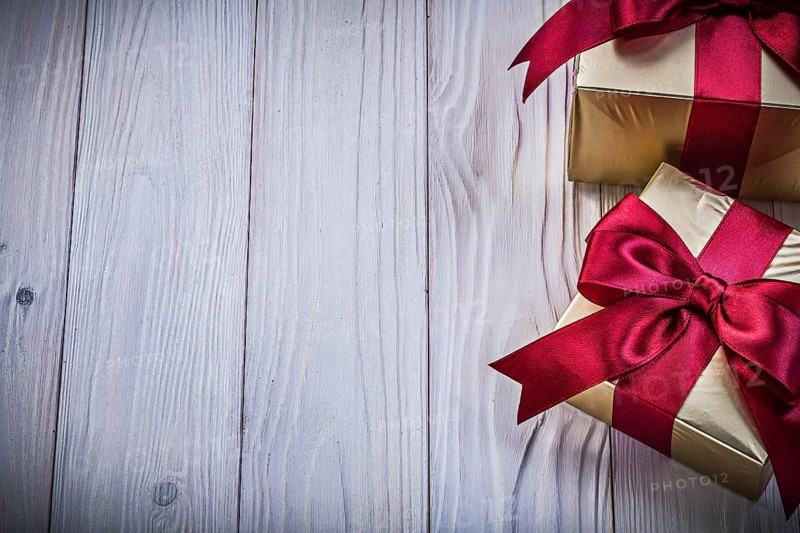 Gift boxes with ribbon on wooden board copy space holidays concept