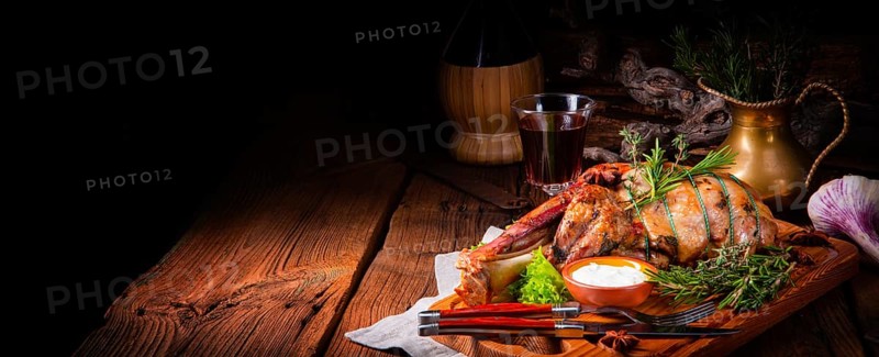 Grilled shoulder of lamb braised in the oven with rosemary