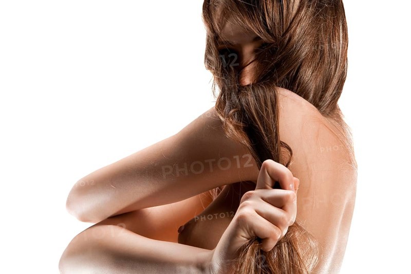 Closeup portrait of a nude young woman, isolated on white