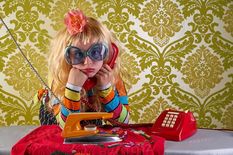 Sad housewife kid girl iron chores talking at red retro phone vintage humor
