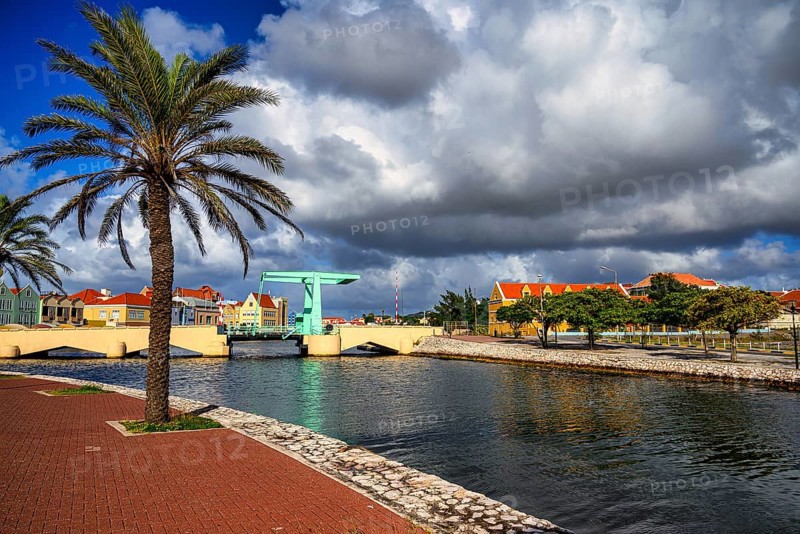 A view of a bridge in willemstad on curacao with blue sky and beautiful clouds