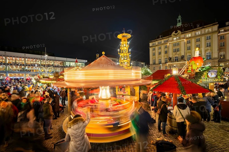 The Dresden Striezelmarkt is a Christmas market in Dresden. It has been held in Advent since 1434, usually on the Altmarkt square, and attracts an average of around two million visitors every year. It is the oldest certified Christmas market in Germany. Nostalgic carousel with pyramid. Dresden, Saxony, Germany, Europe