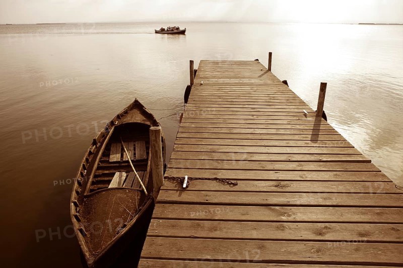 Albufera lake wetlands pier with boat in Valencia Spain