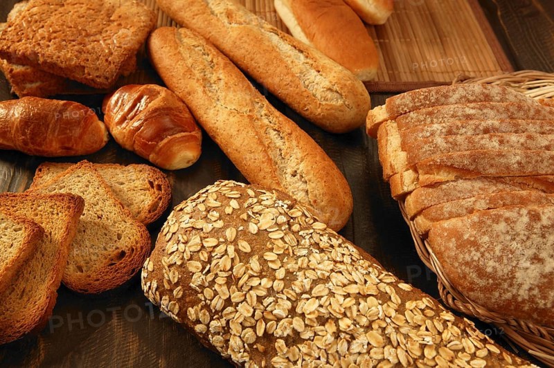 Varied bread still life over dark wood background