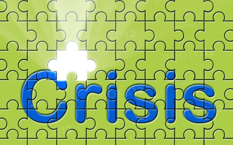 Crisis text written on a puzzle background with missing piece