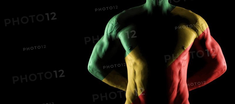 Republic of the Congo flag on muscled male torso with abs, black background