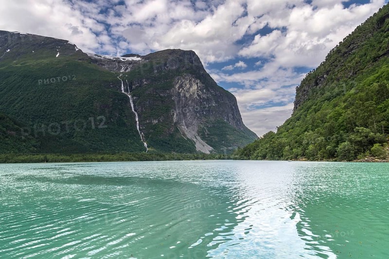 The Kjenndalsbreen is part of the Jostedalsbreen, one of the largest glaciers in Norway, and forms an impressive mountain landscape with a beautiful lake in Sande. The glacier Kjenndalsbreen with a lake in Norway is a beautiful place to travel to in summertime