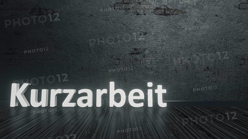 Text short-time work in german language on a black floor 3d illustration