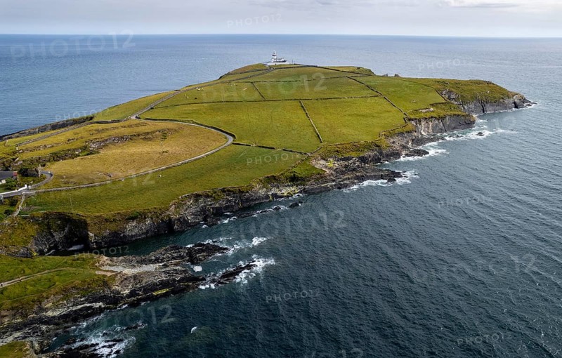 Drone aerial seascape of galley head lighthouse. Dundeady headland island cork county ireland