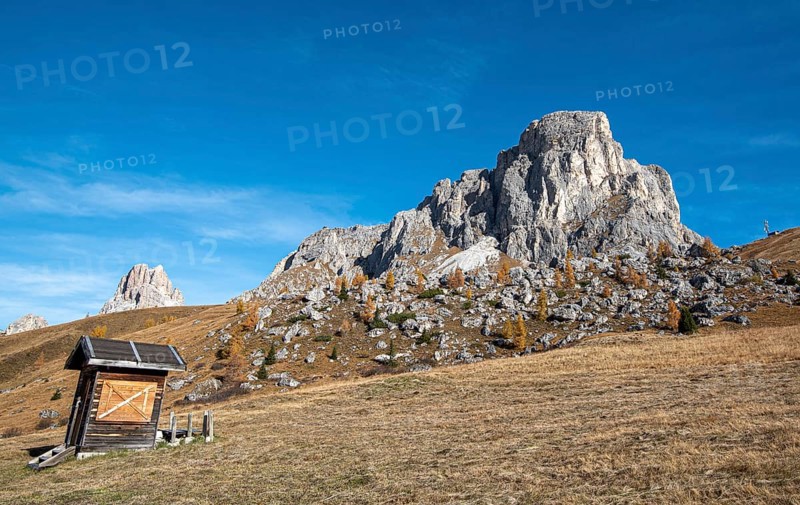 Beautiful mountain landscape with Dolomite rocky peak and a wooden lodge at picturesque Passo Di Giau in the Alps of South Tyrol in Italy