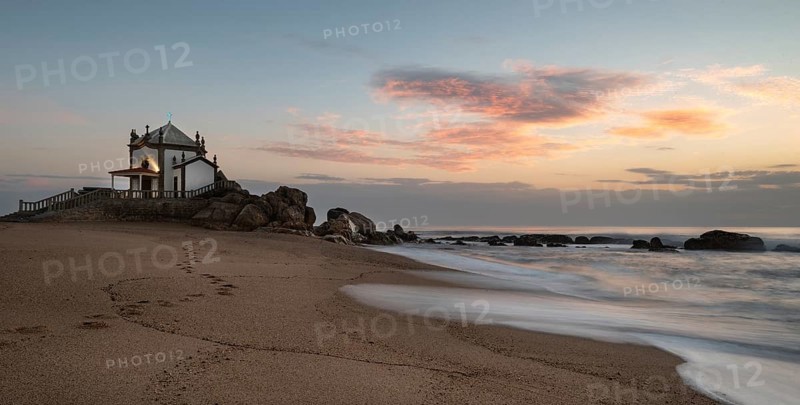 The famous and Picturesque church of Senhor da pedra south of Porto in Portugal in the Atlantic ocean during sunset