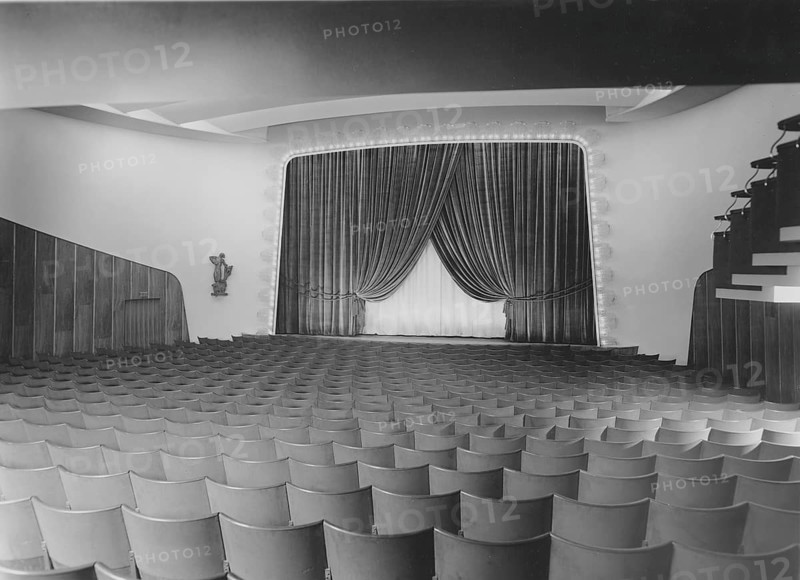 Cinema in the 1940s. An interior of a typical looking movie theatre with seats near the film screen and on the balcony. The screen is covered partly by drapes. Sweden 1940s