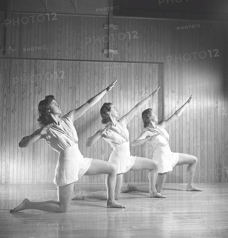 Gymnastics in the 1940s. Three young female gymnasts are practicing together and doing the same movement. 1945 Sweden Photo Kristoffersson ref M107-1