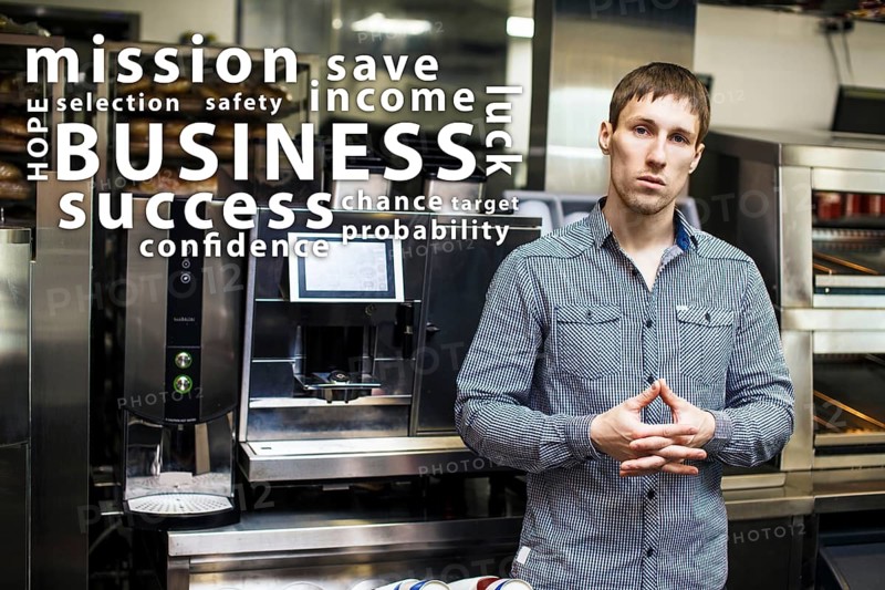 Portrait of worker in coffeeshop shows equipment and words cloud
